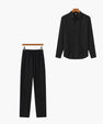 Black long sleeve button-up shirt and matching black drawstring pants set on hangers