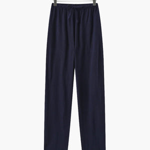 Navy blue casual pants with elastic waistband and drawstring hanging on wooden hanger