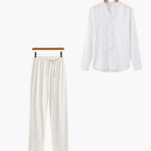 White long sleeve shirt and matching white drawstring pants set on wooden hangers